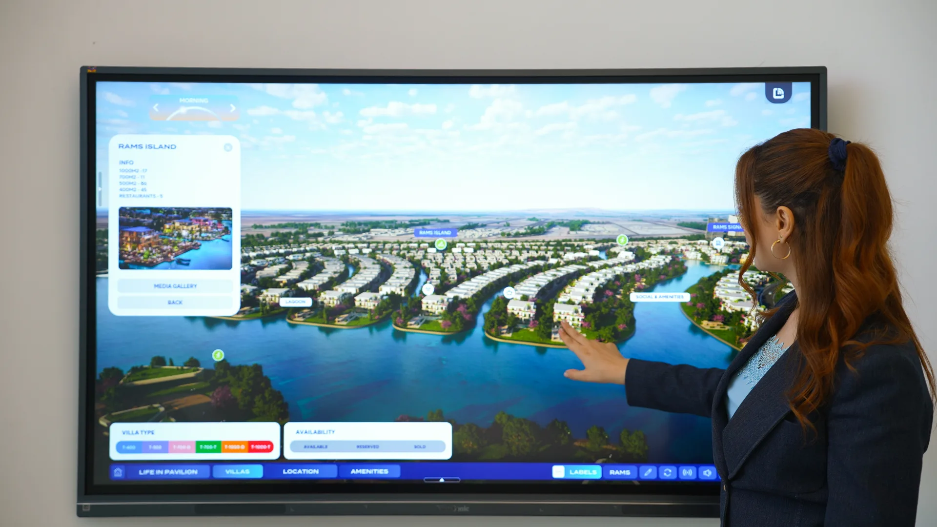 Sales consultant presenting the twin on a wall-mounted touchscreen